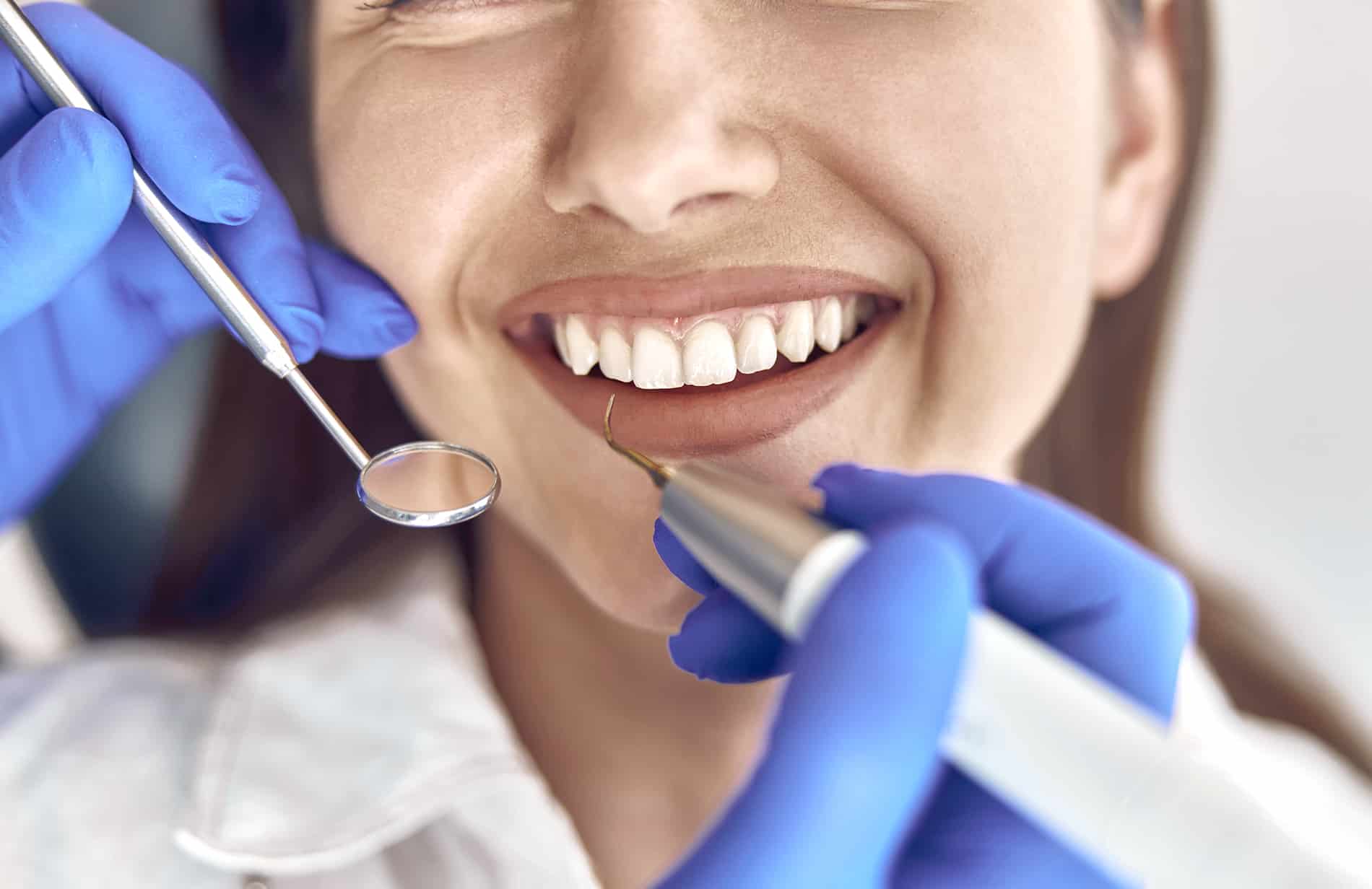 dentist at prosper dental studio with a patient during root canal treatment
