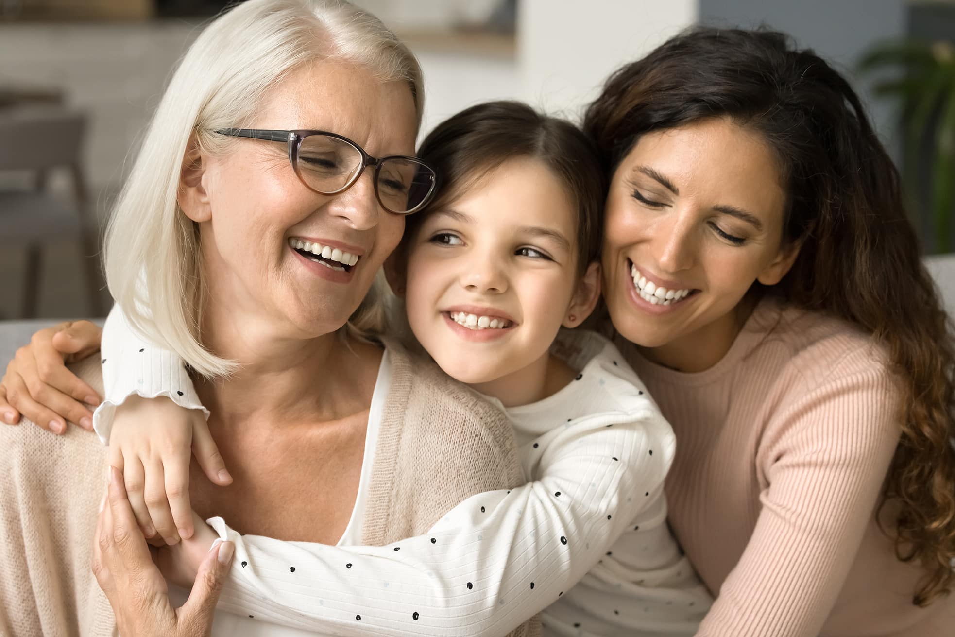 mother and daughter and child laughing and embracing eachother in cornelius nc