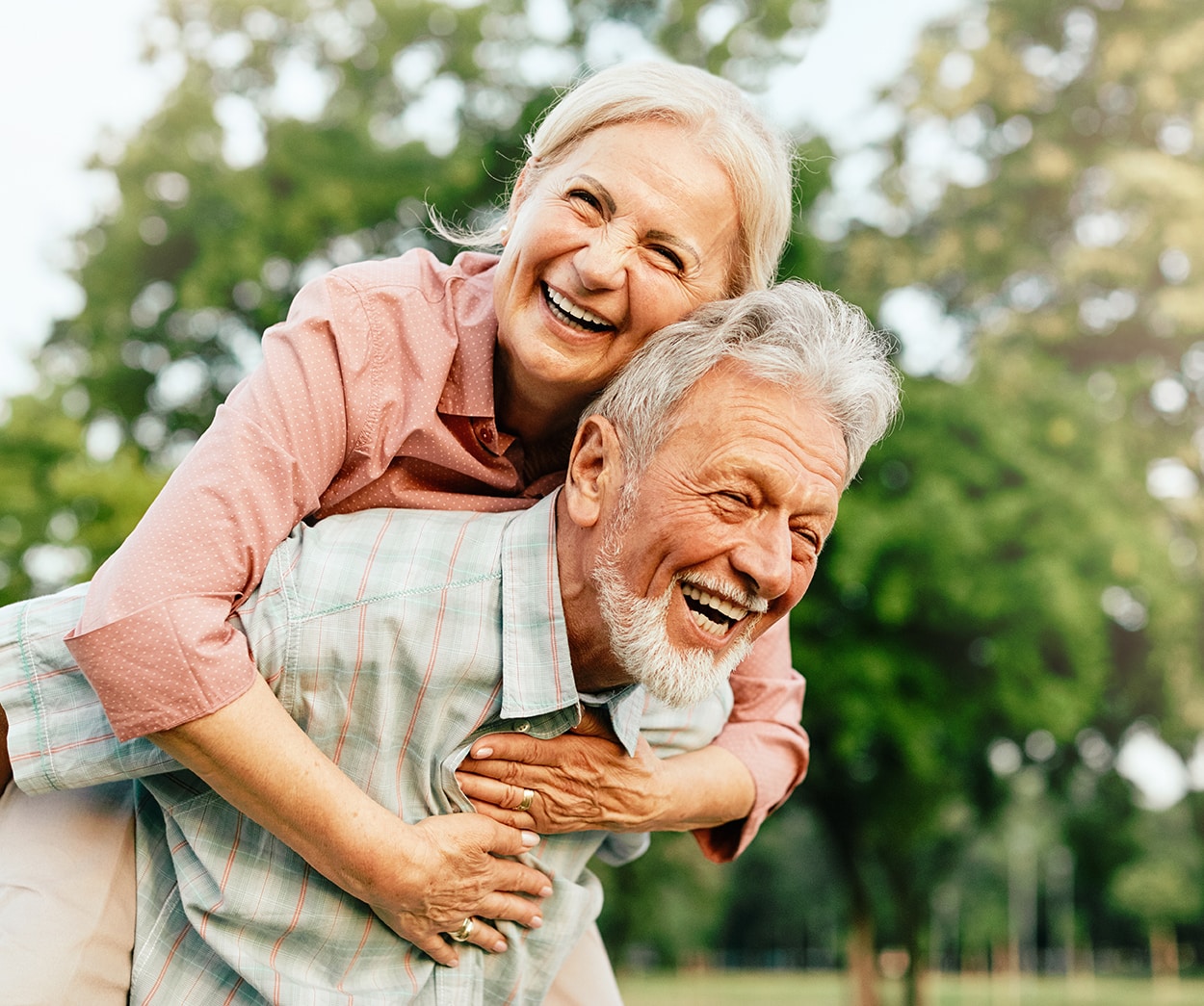 husband and wife laughing outside of Prosper Dental Studio in Cornelius, NC