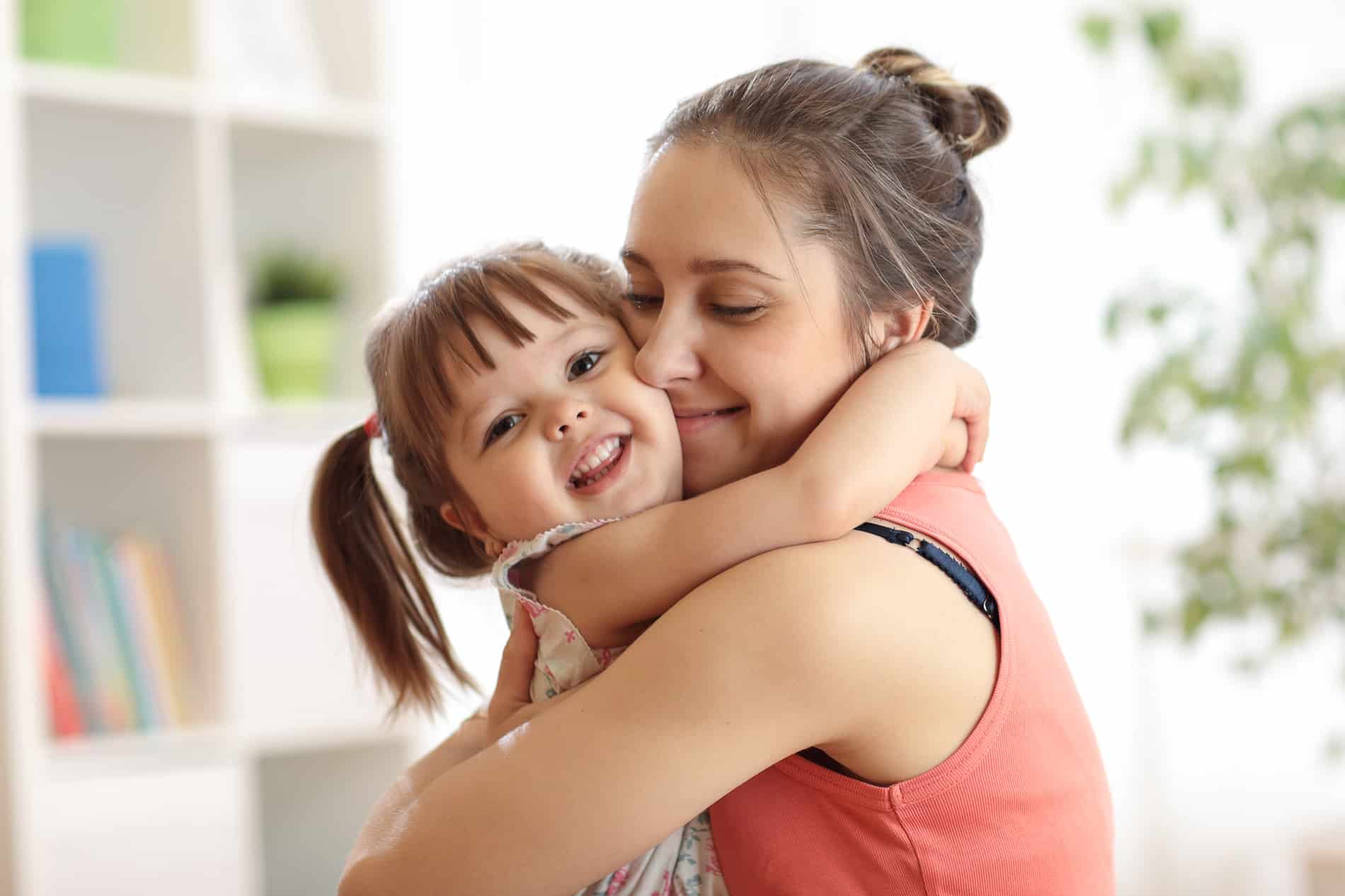 A mother and daughter hugging after a dental exam at Prosper Dental Studio in Cornelius NC