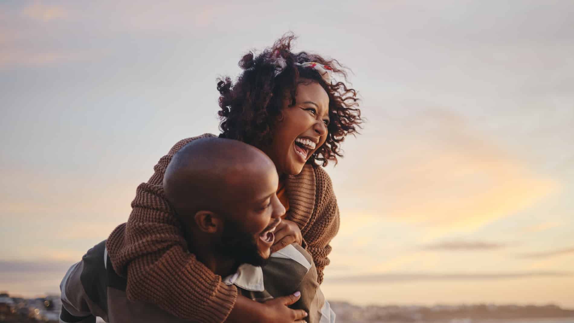 A man and woman laughing and embracing after dental care at Prosper Dental Studio