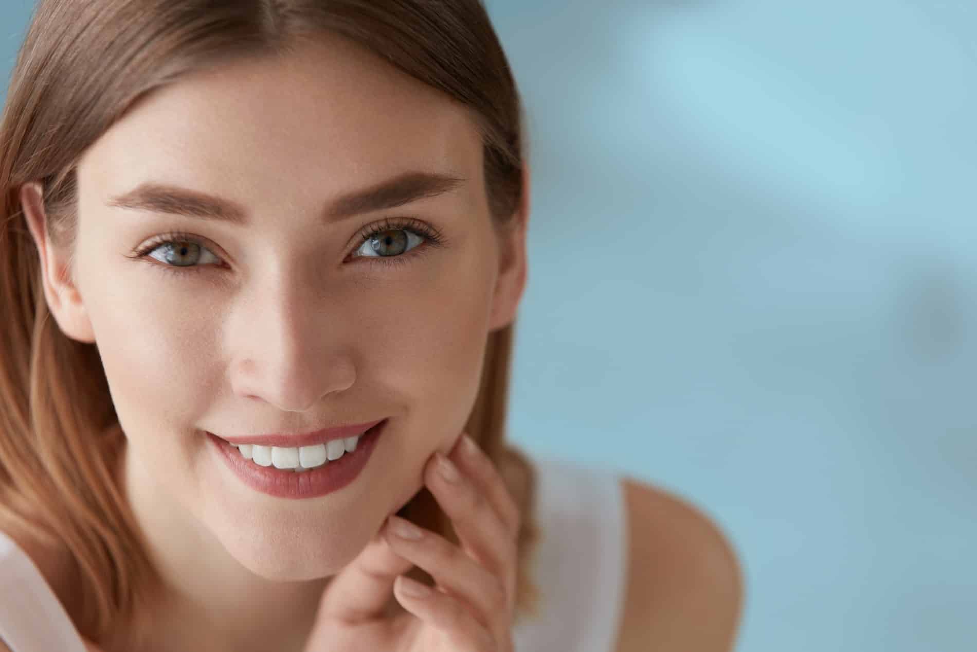 Woman showing off her white teeth after kor whitening at Prosper Dental Studio