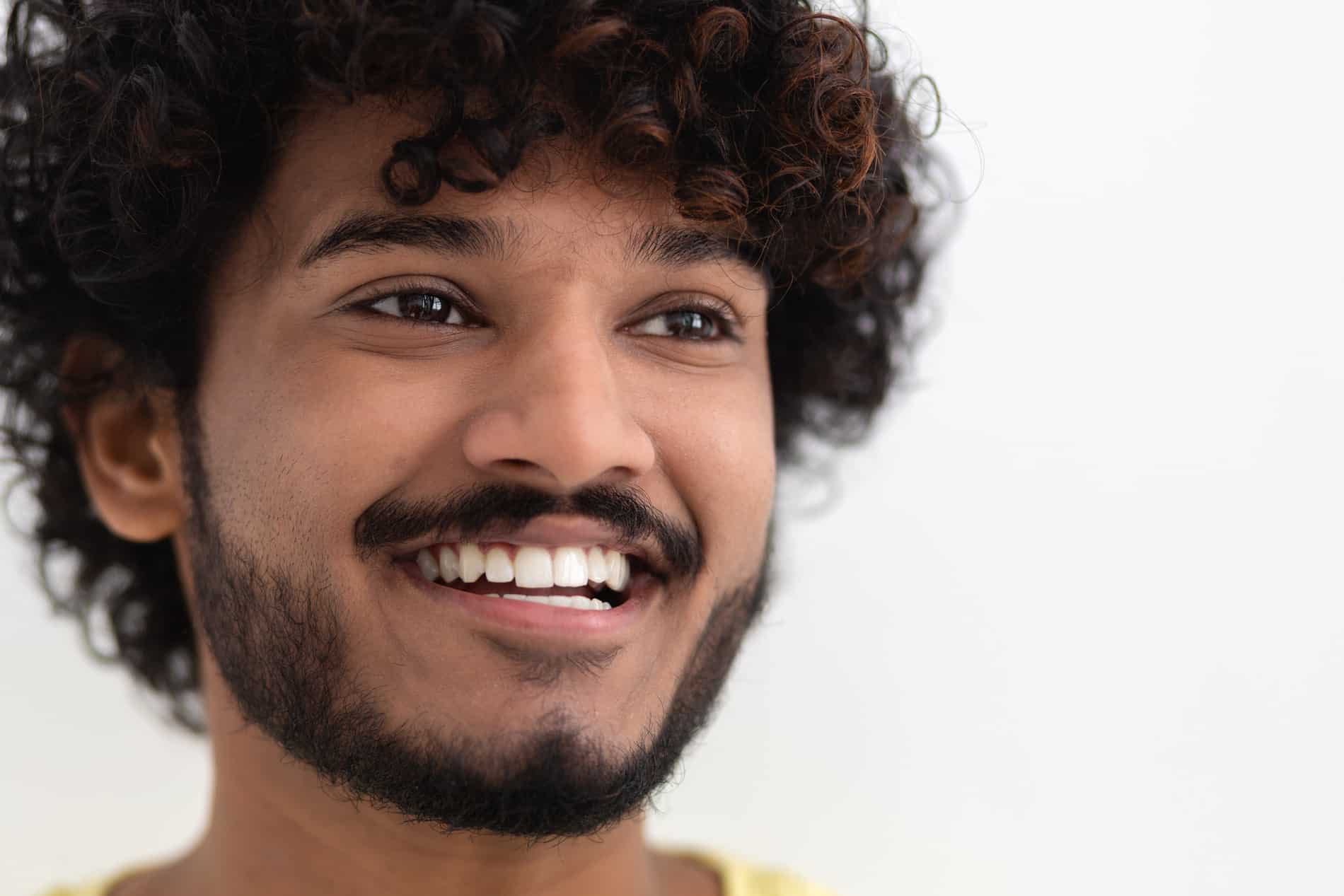 Man smiling with restored gums after an extraction in Cornelius NC