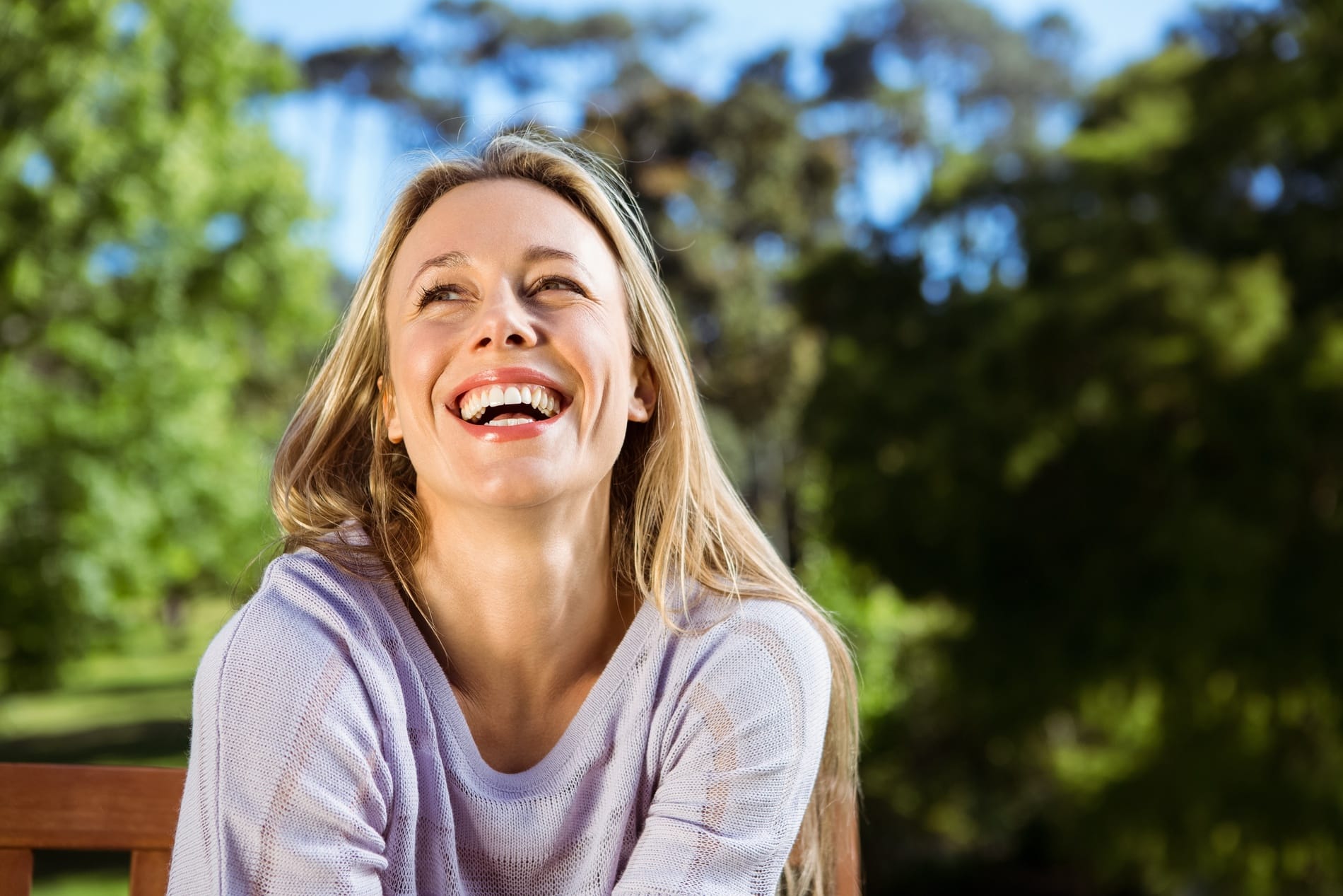Woman smiling after tooth colored filling treatment in Cornelius NC
