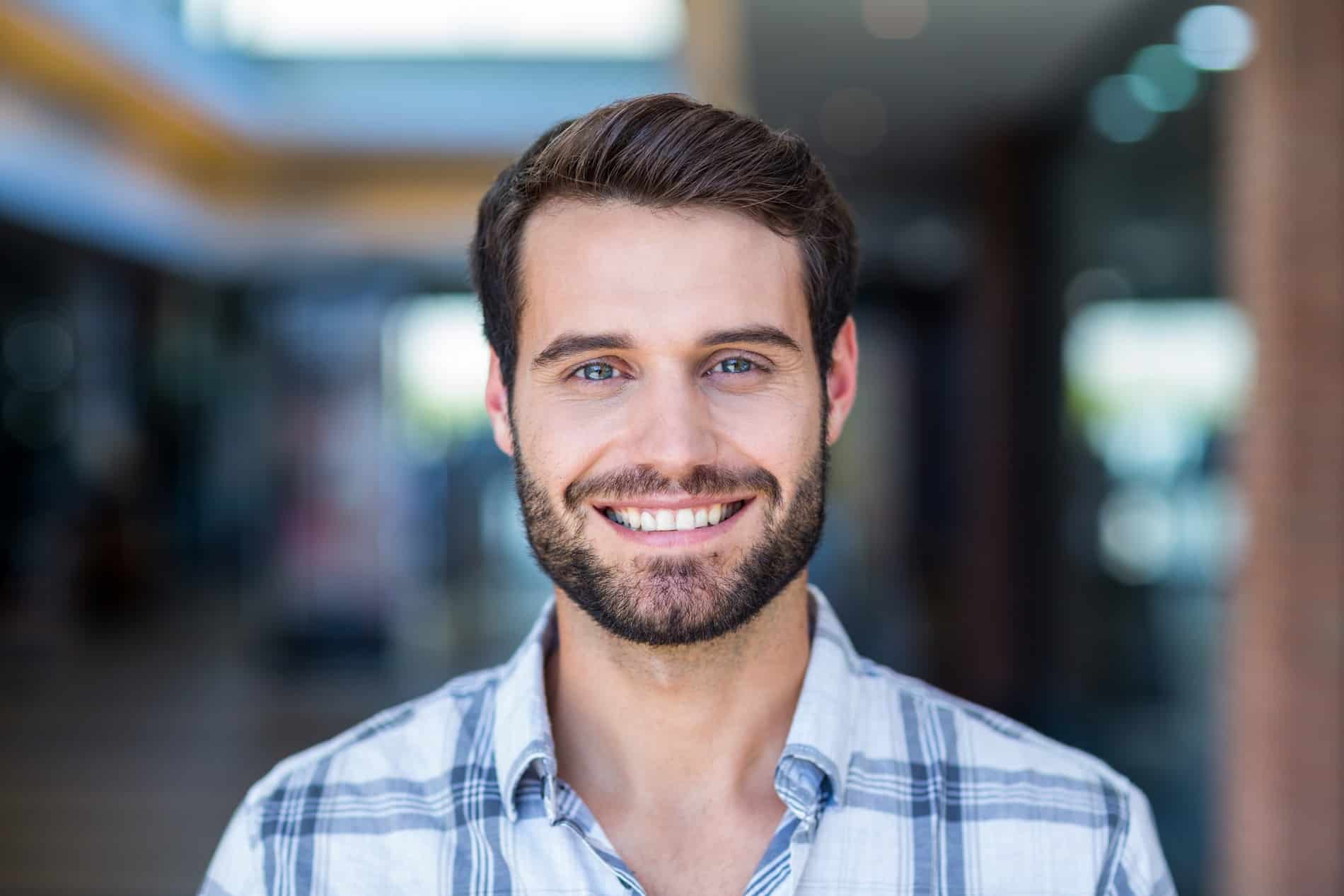 Man showing of his smile with dental bonding from Prosper Dental Studio