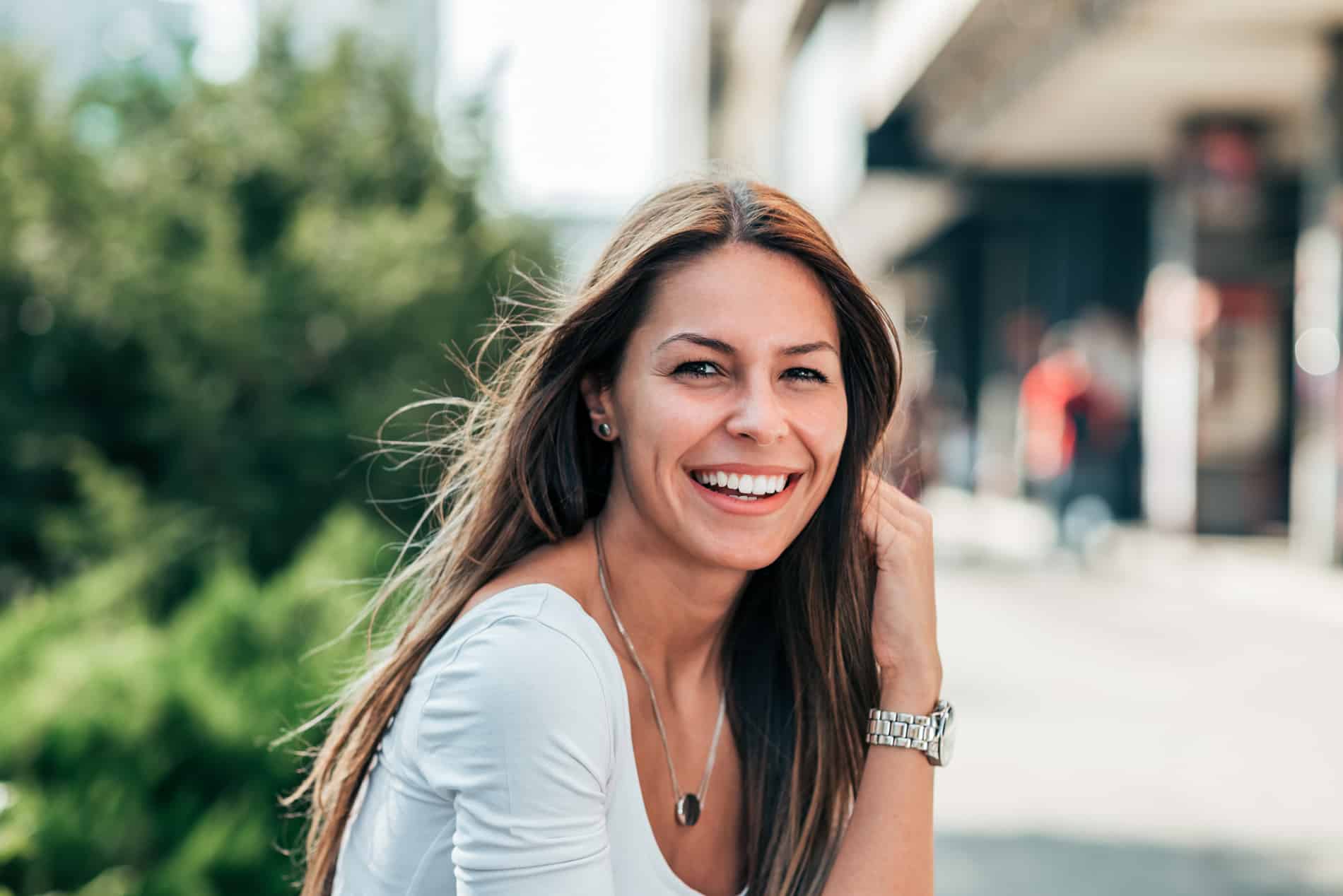 Woman smiling after her restorative crown and bridge treatment with Dr. Chicas