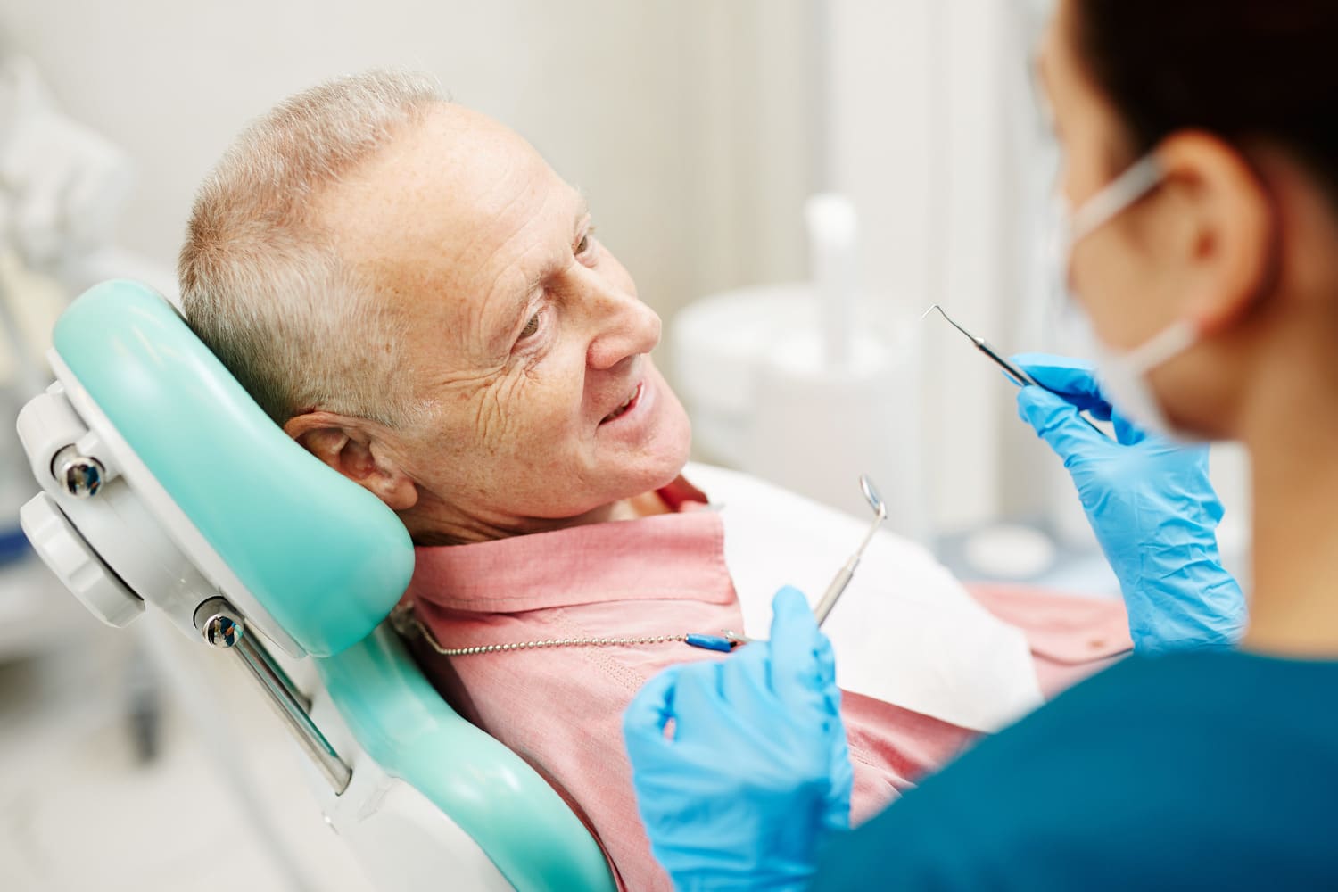 Man learning about crowns and bridges at the dentist in Cornelius